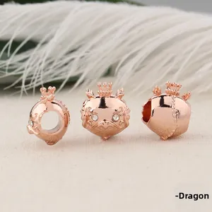 Detailed macro view of rose gold dragon beads with crown accents and crystal eyes
