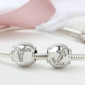 Silver snake chain bracelet featuring crystal-studded anchor and letter bead charms