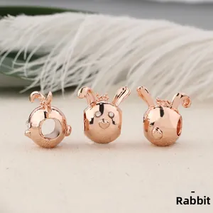Detailed views of rose gold rabbit charms with white rhinestones for jewelry making