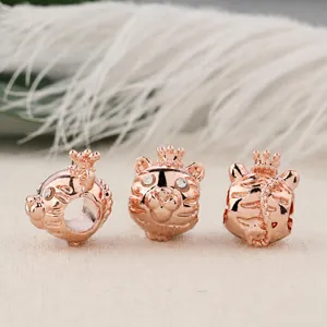 Close-up of rose gold tiger charms with crown and diamonds for beaded bracelets