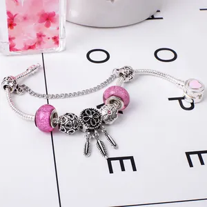 Pink glass bead charm bracelet with dreamcatcher pendant on silver snake chain