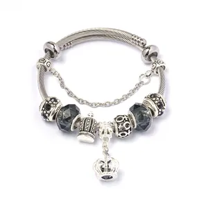 Detailopname van vintage zilveren kralenarmband met kristallen en kroonvormige bedels