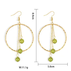 Detail shot of gold hoop earrings with green shell beads and chain tassels, 8.9cm length