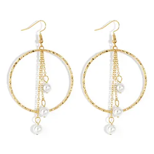 Minimalist gold hoop earrings with textured finish and hanging white pearl tassels