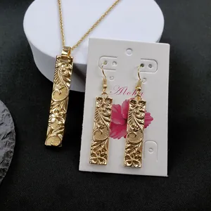 Golden bamboo bar necklace and earrings set with floral relief and Aloha theme