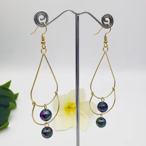 Elegant gold double-layer drop earrings featuring iridescent pearls on a white background
