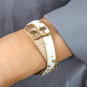 Slim multilayer leopard print leather wrap band for Apple Watch on a woman's wrist