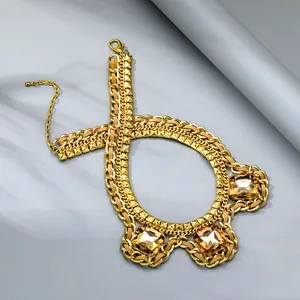 Detail of chunky gold chain necklace with champagne crystals and leather cord accents