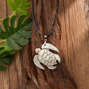 Macro shot of natural shell turtle pendant with iridescent texture on black cord