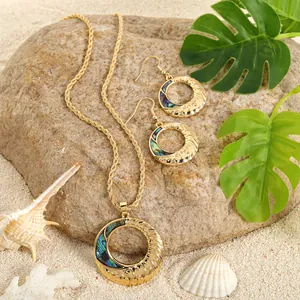 Golden sunflower jewelry set with natural abalone shell on tropical beach background
