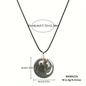 Detailed size view of the 4cm shell turtle pendant with a 45cm black velvet necklace
