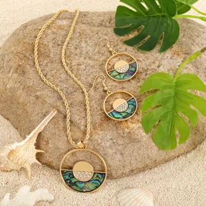 Detail shot of sunflower jewelry set with abalone shell and crystals on beach rock