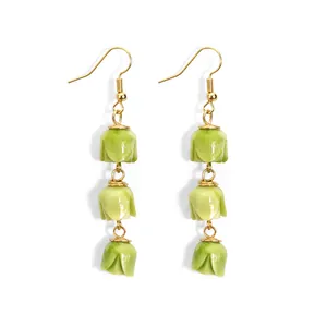 Elegant gold earrings featuring three tiered green tulip flower buds in a drop style