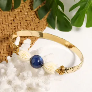 Handmade gold bracelet with tiger eye stone and resin jasmine flower on coral branch