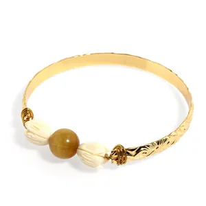 Golden hand-beaded bangle with brown tiger eye stone and white resin jasmine flowers