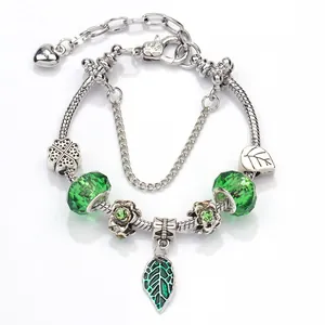 Green crystal beads and silver alloy leaf pendant charm bracelet with clover motifs