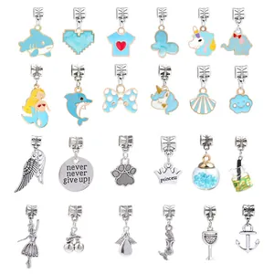 Detail of 24 light blue enamel and alloy charms featuring animals, crowns, and shells