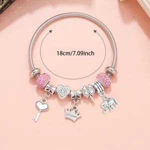 Detail of 18cm silver charm bracelet featuring pink crystals and princess crown pendant
