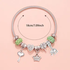 Detail of silver beaded bracelet featuring heart charms and green rhinestones, 18cm length