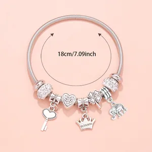Detail of silver charm bracelet with princess crown, pink heart, and 18cm length scale