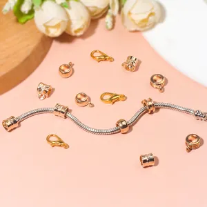 Golden lobster clasp and cylinder spacer beads on silver snake chain for DIY jewelry