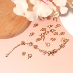 Rose gold DIY jewelry set with connector charms and snake chain on pink background