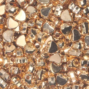 Macro shot of gold heart-shaped CCB spacer beads for DIY jewelry making and crafts