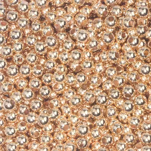 Macro shot of rose gold CCB round spacer beads with smooth metallic finish for jewelry DIY