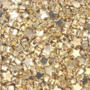 Close-up of golden star-shaped metal beads with side holes for DIY jewelry making