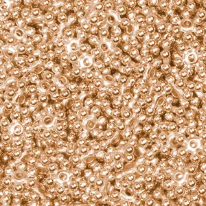 Macro shot of rose gold flower spacer beads with smooth metallic finish and center holes