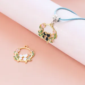 Detail of cat wreath pendant with pink tulips and gold alloy finish for DIY jewelry