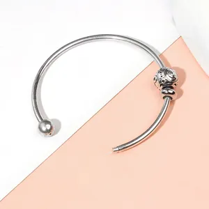 Dettaglio del bracciale argento a C con perla vintage traforata e estremità a vite