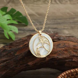 Close-up of gold twist chain necklace with shell coconut tree and wave pendant