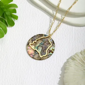 Close-up of golden island silhouette on colorful abalone shell pendant necklace