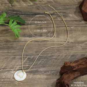 Gold twist chain necklace featuring a white shell round pendant with abstract metal inlay