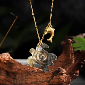Handcrafted Hawaiian style necklace featuring a golden turtle and shell sea creature pendant