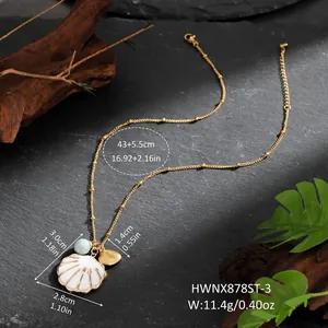 Detail view of golden seashell necklace with dimensions on dark stone background