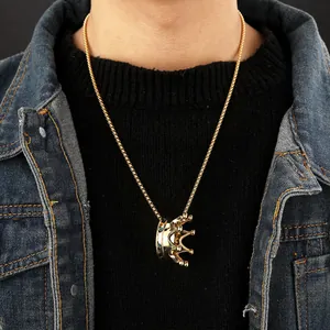 Luxurious 18k gold plated crown pendant necklace with green stones worn by a model