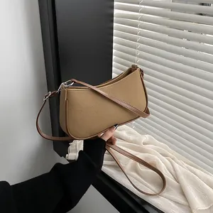 Retro khaki canvas crescent bag with brown leather trim and silver hardware details
