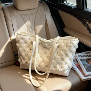 White faux fur bucket bag with wave texture and leather handles on car seat