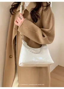 Close-up of white minimalist hobo bag with silver chain and FASHION & BAGS branding