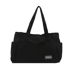 Large capacity black nylon tote bag for commuting with side pockets and fashion label