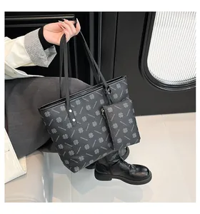 Détail de l'ensemble sac cabas noir avec imprimé trèfle et poignées rivetées robustes