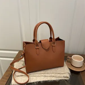 Elegant brown faux leather tote bag with dual handles and gold hardware for daily commute