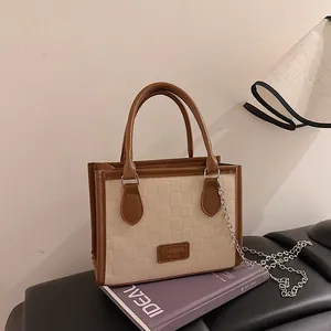 Chic cream checkered embossed shoulder bag with brown leather trim and metal chain strap