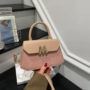 Minimalist beige and brown herringbone woven crossbody bag with gold M-buckle