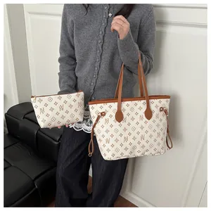 Close-up of stylish bucket tote with matching pouch featuring brown geometric floral print