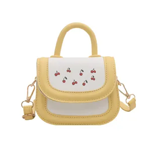 Mini yellow cherry print shoulder bag for kids with top handle and golden strap hooks