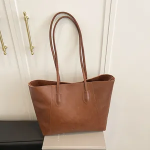 Classic brown pebble leather tote bag with long handles and a large capacity for commuting