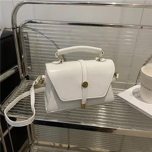 Minimalist white square crossbody bag with vintage gold buckle and leather handle